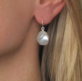 Enhance your jewelry collection with our cultured freshwater Keshi pearl earrings on sterling silver sleeper hoops. These genuine freshwater pearls are expertly cultured and grown in mussels found in pristine freshwater ponds, lakes, and rivers. Taking between two to six years to mature, each pearl is handpicked for its unique shape and tone, ensuring no two pairs are alike.